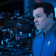 Seth MacFarlane in his Orville costume next to a camera.